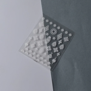 Macro detail of 5D white embossed baroque nail stickers with diamond totem patterns