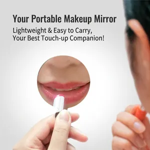 Portable stainless steel round makeup mirror shown being held by a hand for travel