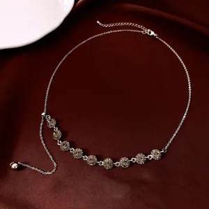 Exquisite silver necklace with nine round grey zircons on elegant dark red silk fabric