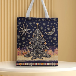 Close-up of a navy canvas Christmas tote bag with golden holiday prints and white handles