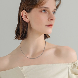 Detail of s925 sterling silver rope chain necklace worn on a neck showing the texture