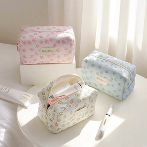 Three floral and pineapple print makeup bags in pastel colors with large capacity
