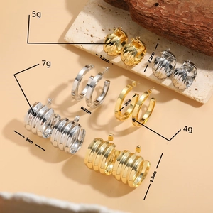 Minimalist gold and silver hoop earrings in twisted design with size and weight specs