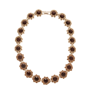 Vintage gold necklace featuring floral links with brown crystals and orange rhinestones