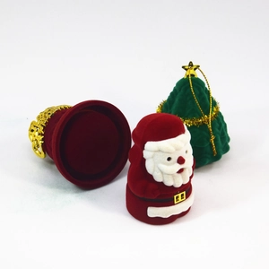 Detailed view of Santa and Christmas tree jewelry boxes with a red velvet interior case