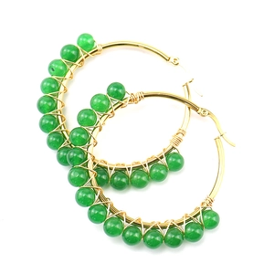 Detail of green natural stone beads wire wrapped on gold stainless steel hoop earrings