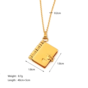 Gold stainless steel book locket necklace with heart detail and product dimensions