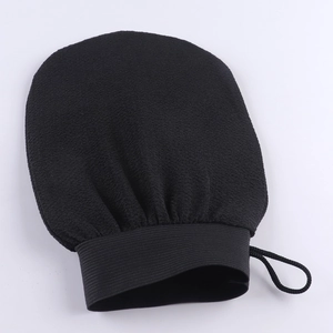 Close-up of black exfoliating glove with scrub texture, elastic wrist and hanging loop