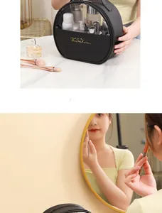 Detail of black PU travel toiletry bag with transparent top and gold zipper closure