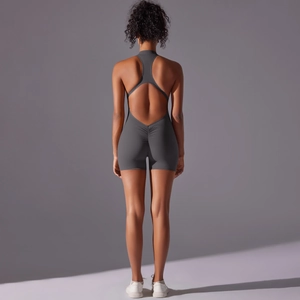 Deep grey yoga romper with racerback, open back, and scrunch butt detail on shorts