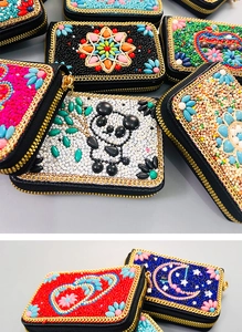 Detail of bohemian handmade beaded coin purses with ethnic patterns and gold chain edges