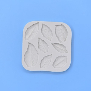 Light gray silicone leaf mold with seven detailed plant leaf cavities for DIY fondant cake baking