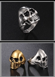 Detailed macro view of vintage skull rings in antique silver and gold finishes