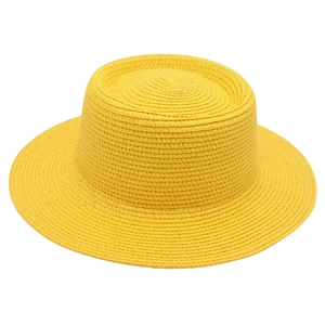 Detailed close-up of lemon yellow straw hat showing intricate spiral weaving texture