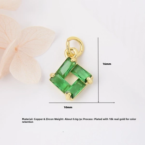 Macro view of 18K gold-plated copper pendant featuring green baguette-cut zircons