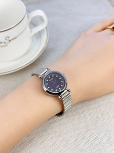 Detail of a ladies' quartz watch with blue rhinestone dial and silver steel strap