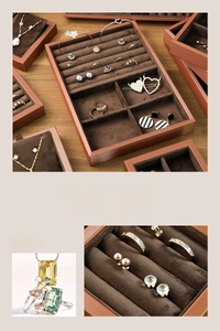 Detail view of brown leather jewelry tray with soft velvet inserts for rings and earrings