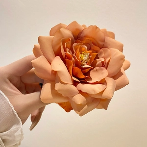 Caramel orange orchid flower hair claw clip with rich fabric petals for hair styling
