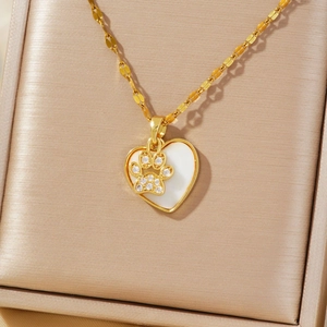 Golden heart necklace with zircon paw print and white shell inlay on satin fabric