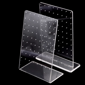 Detailed view of clear acrylic earring display stands with multiple holes for jewelry