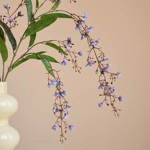 Long-stem artificial blue jasmine branch in elegant vase for home interior floral decor
