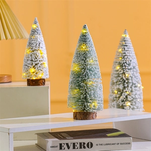 Mini flocked Christmas tree with warm LED lights and a wooden base for desktop decor
