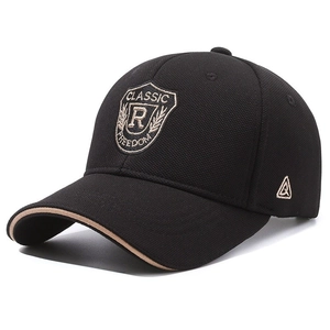 Black embroidered baseball cap with shield patch and khaki brim detail for outdoor sports