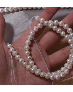 Close-up of 7mm near-round natural freshwater pearls strands with high luster finish