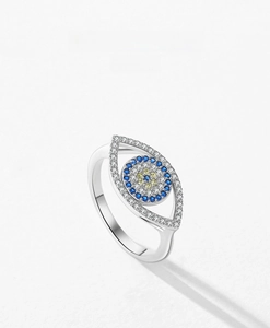 Macro detail of S925 silver Evil Eye ring featuring crystal pavé and blue gemstones