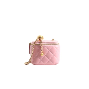 Detail of pink quilted leather mini vanity bag with golden chain and ball adjuster