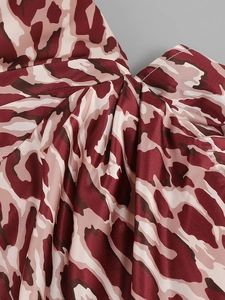 Detail of leopard print satin fabric showing the knot design and smooth silk texture