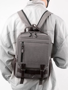 Vintage dark gray canvas backpack with leather trim and multi-pocket functional design