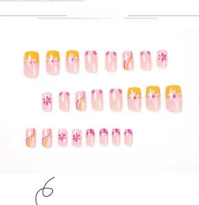 Detail view of 24pcs short square press-on nails with yellow wavy design and pink flowers