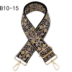 Detailed view of floral baroque embroidery pattern on replacement bag strap with gold clasps