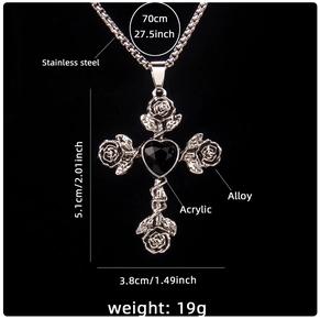 Detailed view of silver cross pendant with rose relief and black heart gemstone