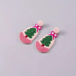 Close-up of handmade beaded Christmas tree earrings with colorful beads and festive details