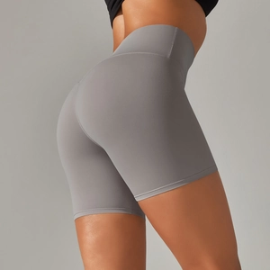 Close-up of high-waisted dark grey fitness shorts showing elastic tummy control fit
