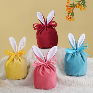 Macro detail of velvet rabbit ear gift bags in burgundy, yellow, pink and blue shades