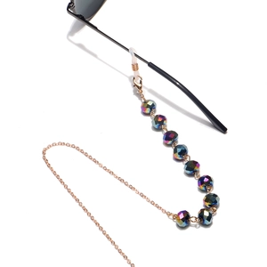 Detail of 10mm flat crystal beads on a golden chain with rubber loops for glasses