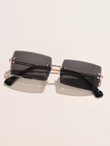 Detailed close-up of rimless square sunglasses with gold metal bridge and grey lenses