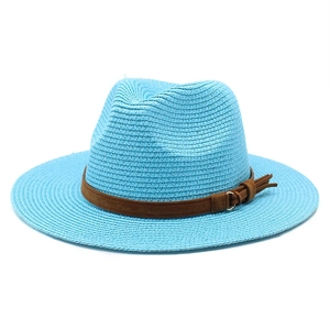 Detail of light blue straw jazz hat featuring brown suede band and gold metal ring