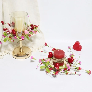 Macro detail of Valentines candle ring with red hearts and pink flowers on golden holder