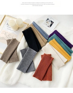 Detailed flat lay of colorful ribbed knit fingerless gloves and warm arm warmers