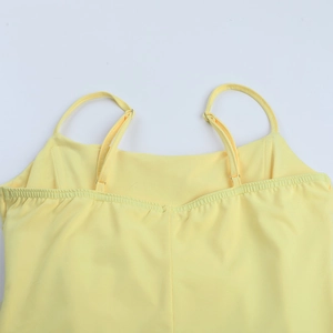 Detail of yellow dress with adjustable spaghetti straps and elastic ruched bodice