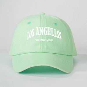 Detailed close-up of Los Angeles vintage embroidery on mint green cotton baseball cap