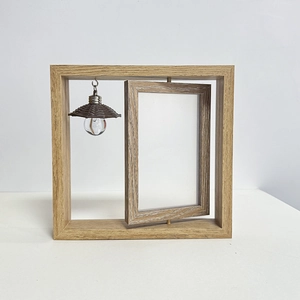 Close-up of a double-sided rotating wooden photo frame with a miniature decorative light bulb