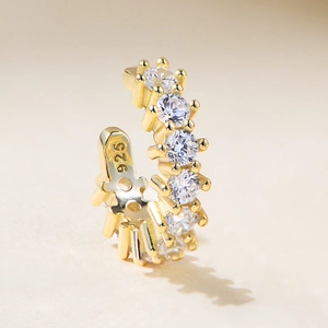 Macro shot of S925 sterling silver stamp and zircon stone setting on golden ear cuff
