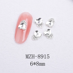 Macro shot of 6x8mm heart-shaped cat-eye nail art crystals with silver metal base