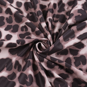 Detailed macro view of the soft leopard print fabric texture and vibrant pattern detail