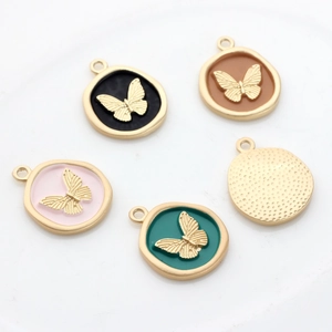 Enamel butterfly charms in four colors and golden back on white background